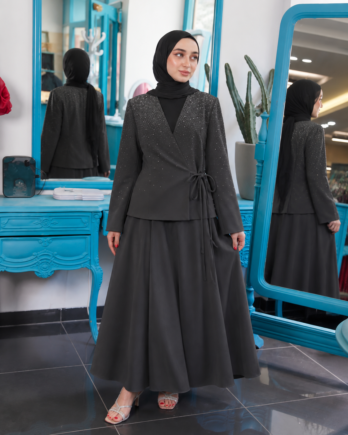 Black wrap-style blazer with subtle embellishment and a long matching skirt.