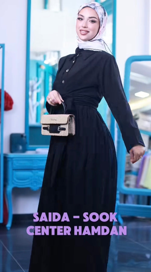 Belted Button Maxi Dress shown in black, with a pointed collar, front buttons, long sleeves and a waist tie.