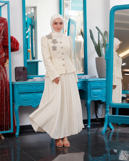 Beige Skirt Suit with a floral-embellished, button-front blazer and a long pleated skirt.