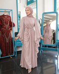 Amara Draped Gown in pink, with a gathered waist, decorative waist accent and long ruffled sleeves.