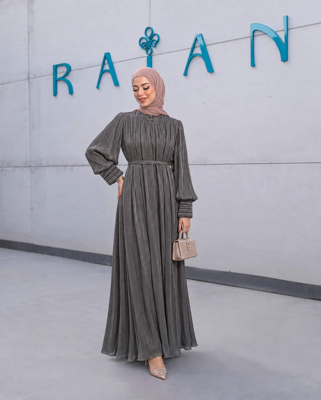 Aveline Gown in black, with vertical pleats, gathered long sleeves and a slim waist detail.