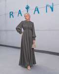 Aveline Gown in black, with vertical pleats, gathered long sleeves and a slim waist detail.