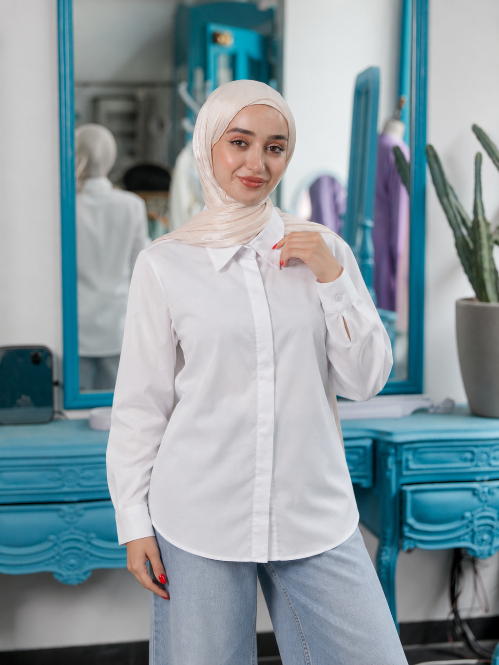 Classic Chemise in white, with a pointed collar, button front, long cuffed sleeves and a curved hem.