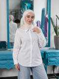 Classic Chemise in white, with a pointed collar, button front, long cuffed sleeves and a curved hem.