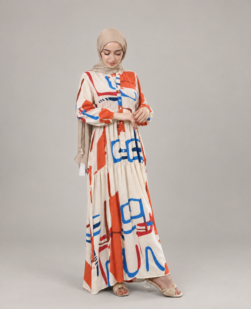Abstract Print Tiered Dress in beige with orange, blue and red print, shown full length with a digitally cleaned studio background.