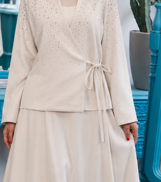 Close-up of Blazer Skirt suit showing cream wrap jacket with tie fastening and textured lapels, cropped from the original product photo.